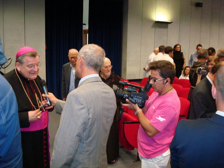 Cardinal Burke being interviewed by press at the collaboration program at the Casa Hospital in San Giovanni Rotondo, Italy
